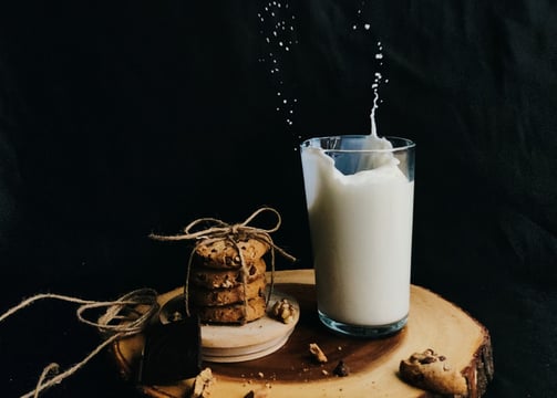 a glass of milk with cookies