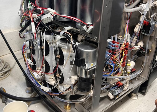 nside view of BUNN Bean to Cup coffee machine during service showing wiring and boiler components.
