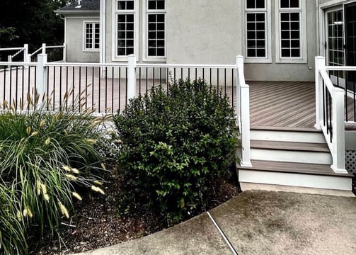 a house with a white fence and a fenced in area
