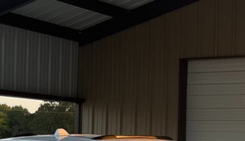 Covered carport with wooden beams.