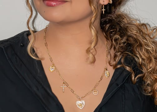 a woman with a black shirt and gold jewelry