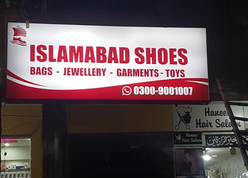 a sign for a shoe shop in a store