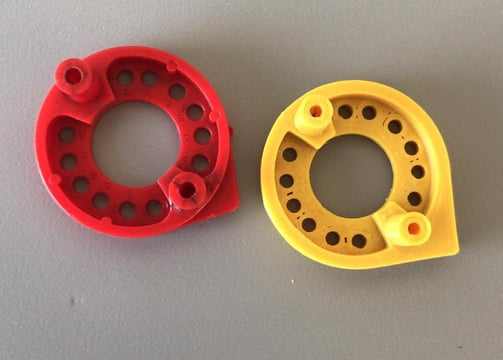 two red and yellow plastic rings with holes in them