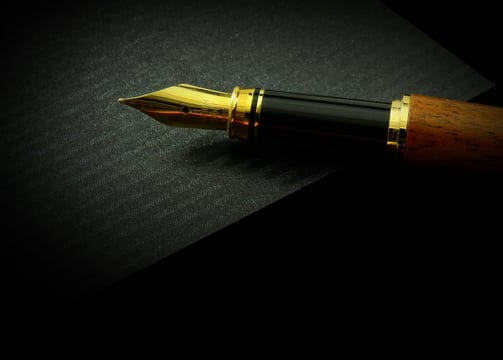 a pen and a pen on a black background