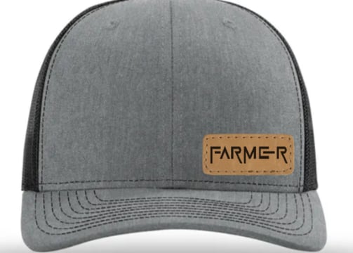 a gray and black hat with a leather patch on the front of a hat