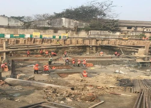 a group of people standing around a construction site