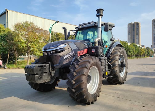 a 260HP tractor with a large tire on the side of the road