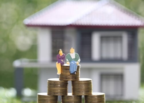 a couple of people sitting on top of a pile of coins