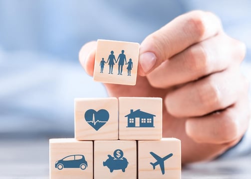 a person holding a wooden block with icons of people