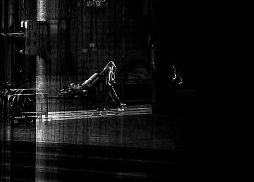 A man, with a ghost like shadow, taken through glass at The Usher Hall. Edinburgh