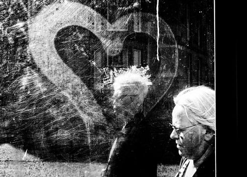 Two women walk past a bus shelter on Palmerston Place, Edinburgh