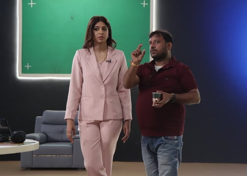 a man and woman standing in front of a green screen