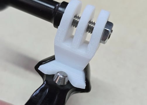 Uni-Mount white "Single" mount mounted on exposure clamp