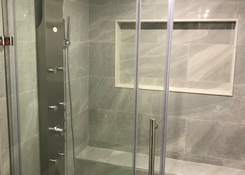 renovated bathroom with glass door standing shower. Basement finishing with bathroom and kitchen.