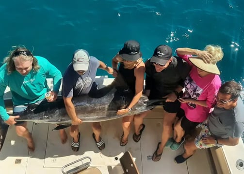 a group of people standing on a boat