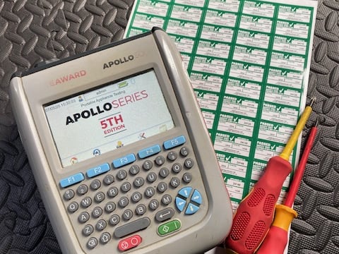 a multi-tester with labels and screwdrivers