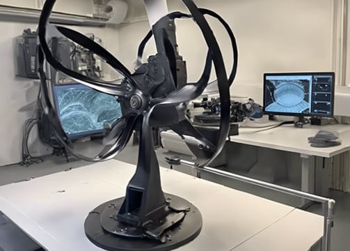 A metal-cutting machine in action, with a saw blade slicing through pipes and coolant fluid being applied to reduce heat and friction. The environment has an industrial and mechanical feel with visible metal shavings and gears.