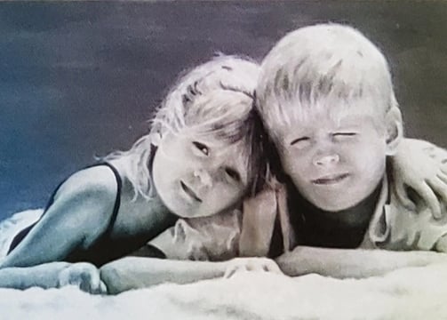 Siblings rendered in soft tones like a quiet chord of warmth and innocence