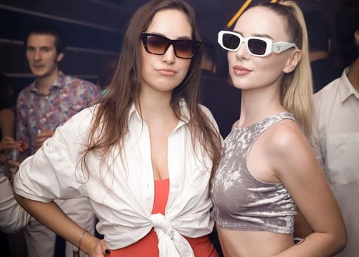 two women in sunglasses and sunglasses standing next to each other