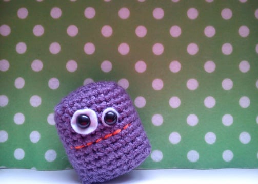 a purple crochet with eyes and eyes, a small purple crochet