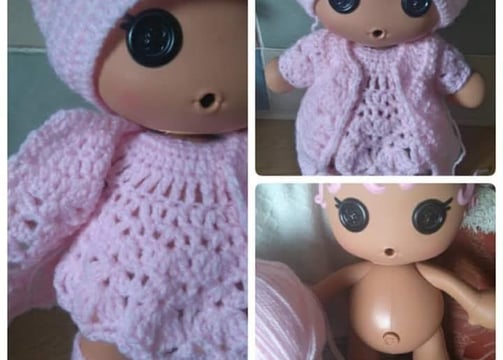 a doll doll with a pink crochet outfit and a pink hat made to measure
