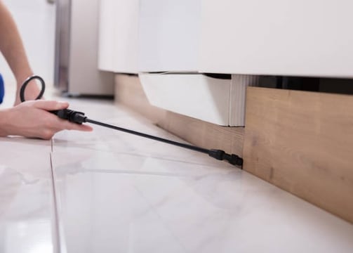 a person is using a cord cordless device to remove a kitchen floor