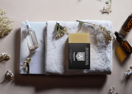 a towel with a bottle of essential oils on it
