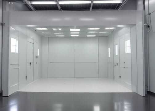 The interior of a factory or assembly line is visible, with several workstations lined up neatly. Each station contains white plastic enclosures with electronic components inside, suggesting an electronic manufacturing or assembly process. Overhead lighting and blue tool boards are present, with some orange coiled cords hanging down.