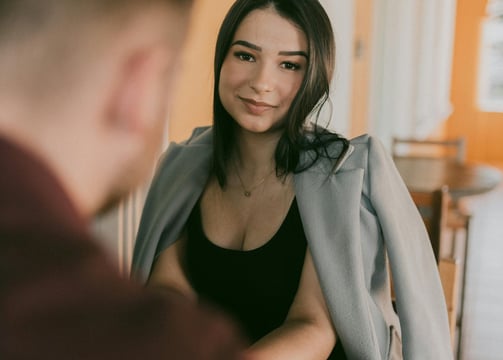 a woman in a black top and a man in a gray jacket
