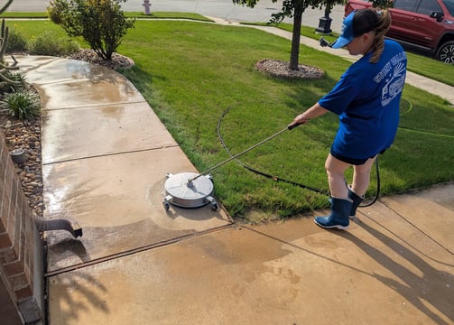 Cleaning a side walk in Ponder Texas.