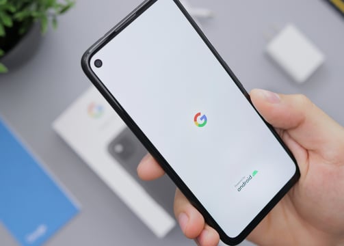 A person holding a phone in their hand.