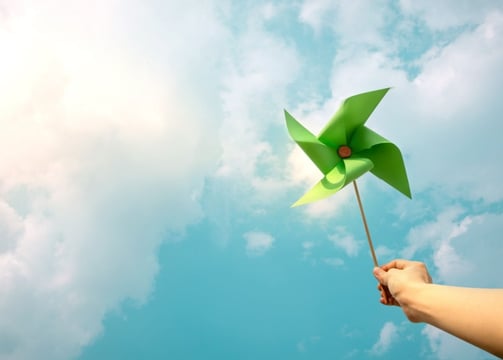 a person holding a pinwheel in the sky