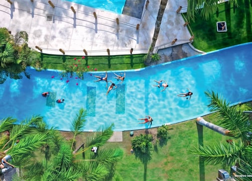 a group of people swimming in a pool