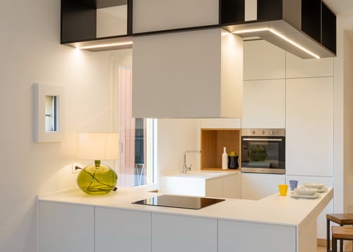 a kitchen with a white counter top and a vase with a vase on it