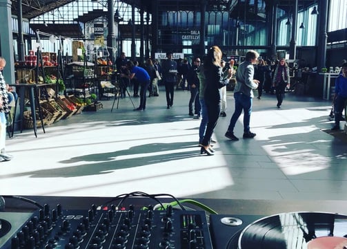 a dj - zoller mixing music in a large room