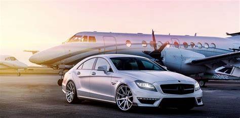 a mercedes cla parked in front of a plane