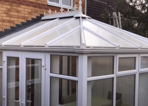 a white conservatory attached to a house