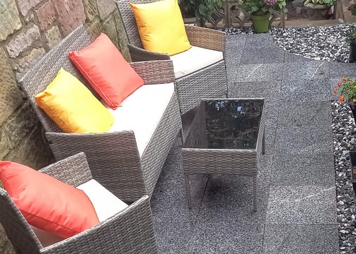 a patio with a couch and a table