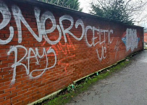 a brick wall with graffiti on it