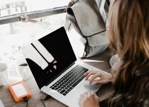 A woman typing on a computer. Photo by Andrew Neel on Unsplash