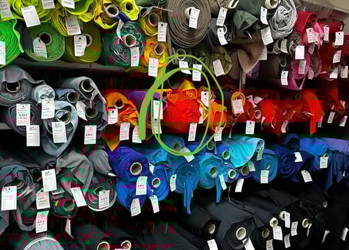a display of many different colorful fabrics