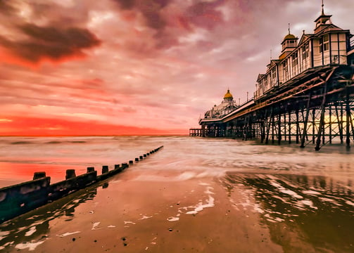 Eastbourne Pier, the sea and a groin at sunrise