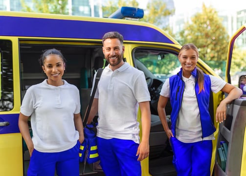 a group of people standing in front of a medical transportation