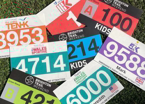 a photo of a stack of colorful race bibs