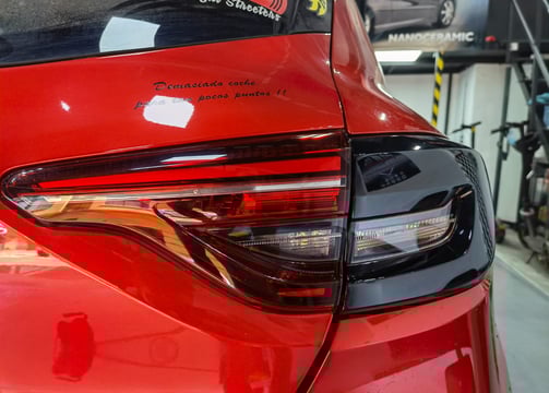 a red car with a sticker on the back of it