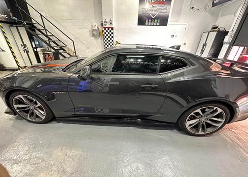 a car in a garage with a checkered window
