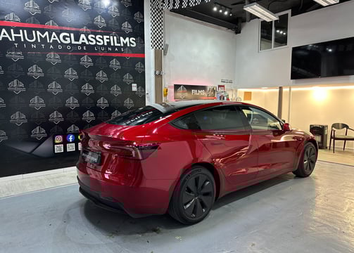 a red tesla model car is shown in a showroom