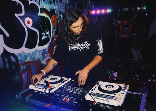 a man in a black shirt is playing a dj - Creechur
