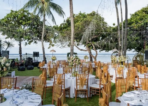 Beach wedding decoration with white drapes and tropical flowers by Pune wedding planning experts