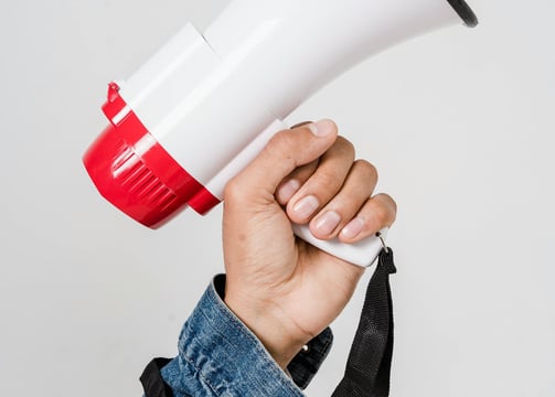 a person holding a red and white megaphone